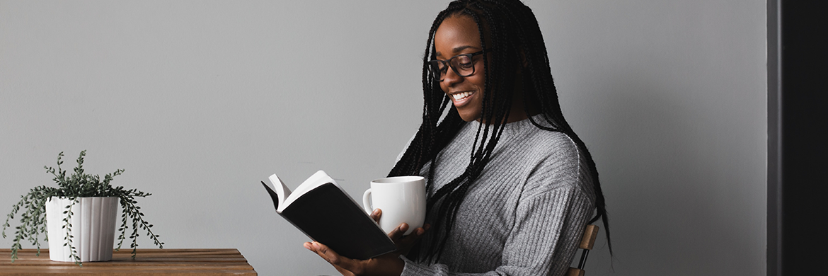 Woman smiling while reading